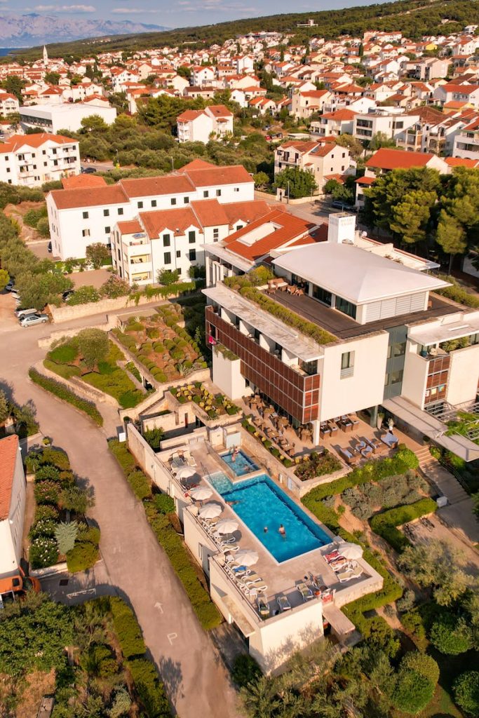 An aerial view of a resort with swimming pool and a large house